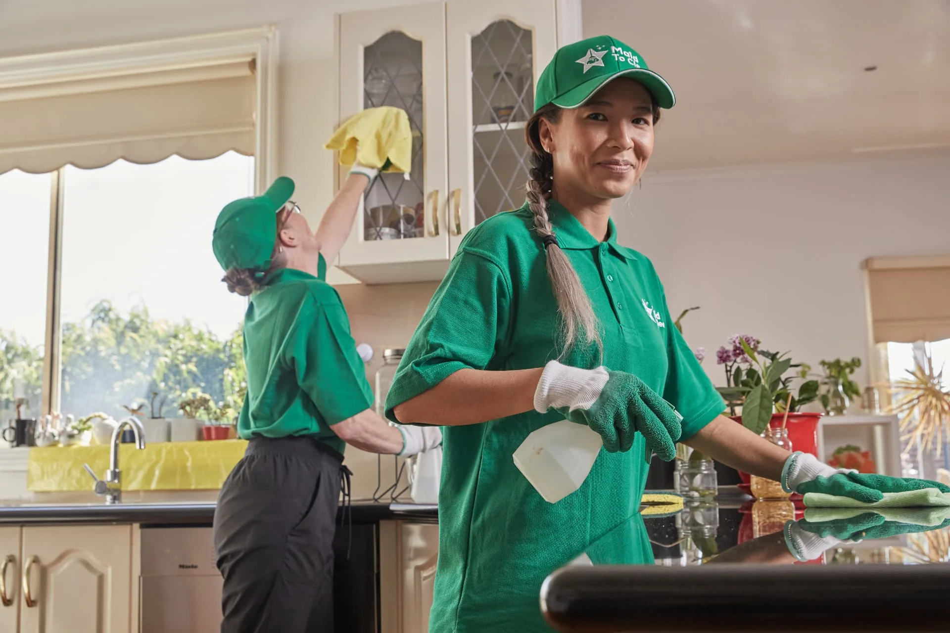 Two Maid to Clean cleaners tidying a bright family kitchen
